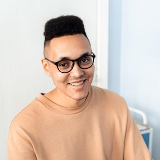 Smiling customer wearing glasses from UK shares product review